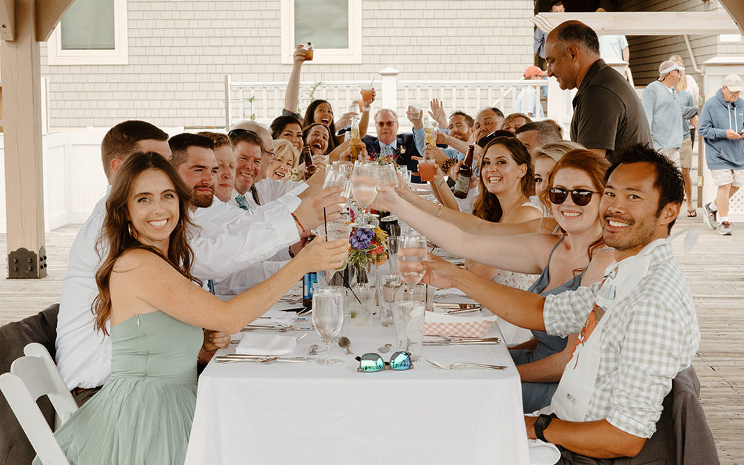 Intimate elopement reception with guests cheering 