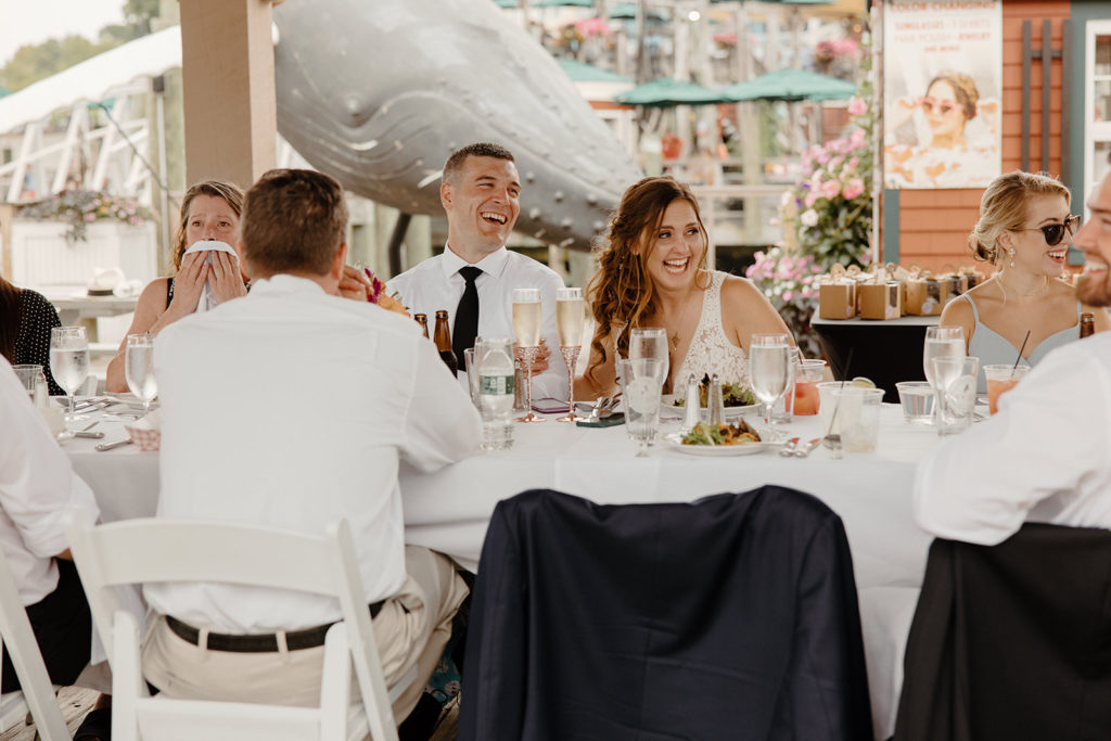 Intimate wedding ceremony with bride and groom surrounded by family laughing