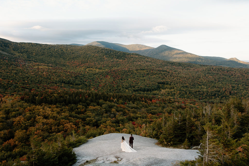 Bride and groom elopement photo in New England fall colored mountain forest