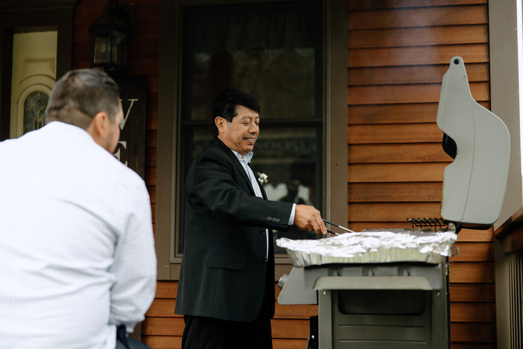 dad cooking bbq for elopement reception