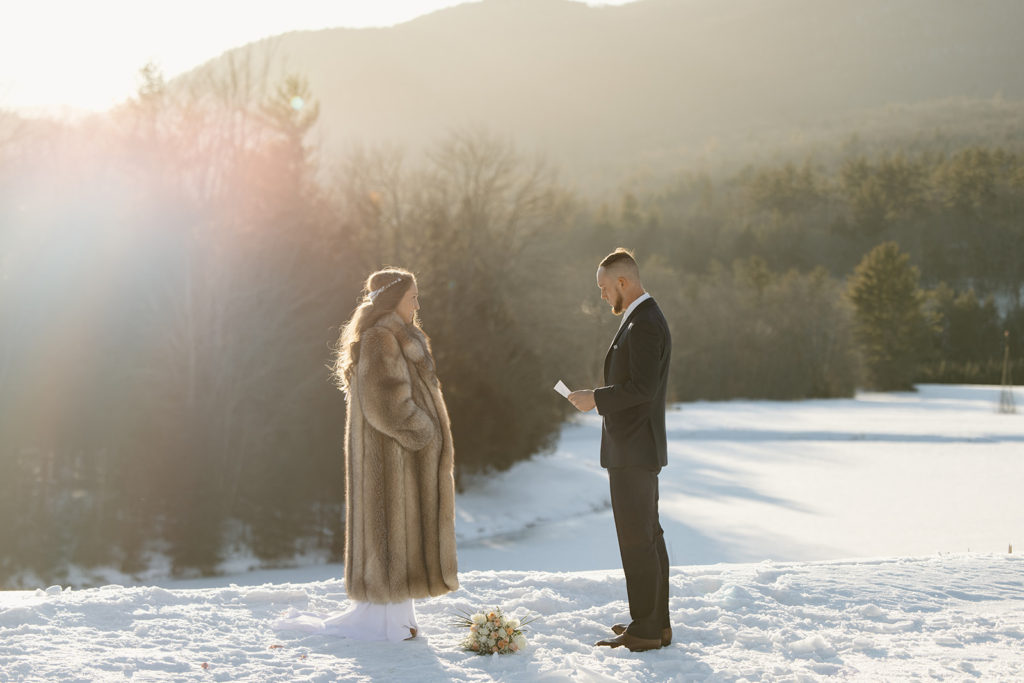 winter elopement ceremony with groom reading vows