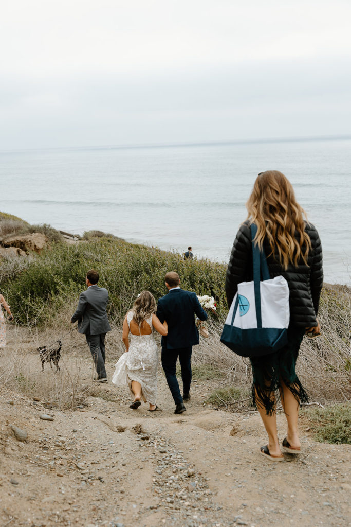 San Diego elopement with guests walking down to the cliffs