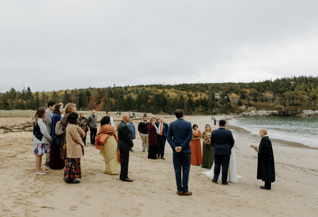 Beach elopement with guests watching
