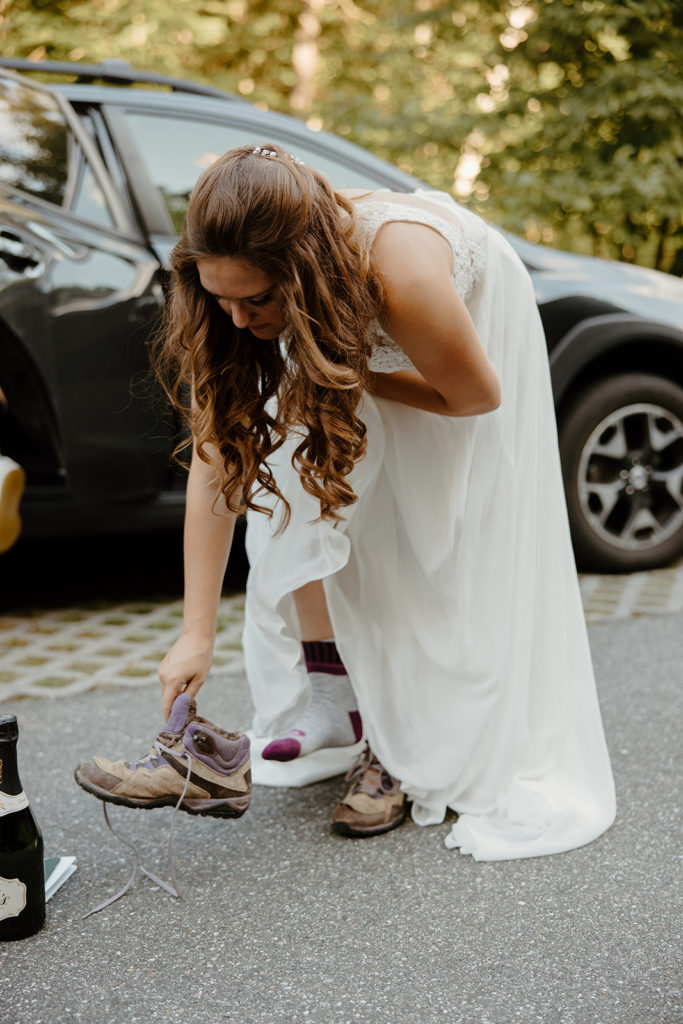 Bride putting on boots at elopement