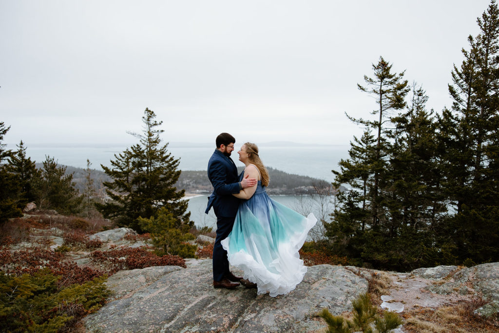 Maine Elopement in Acadia. Bride in blue ombre wedding dress on cliffs