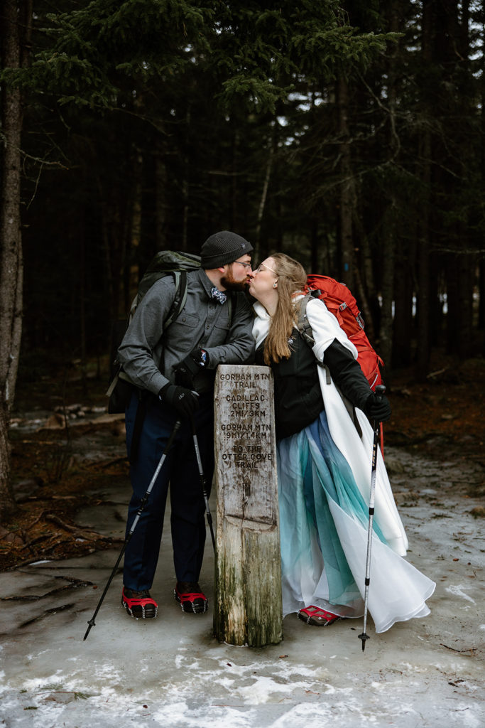 Bride and groom in hiking gear in Winter elopement