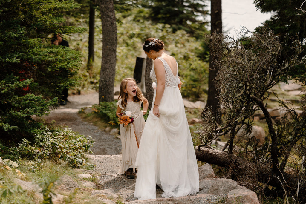 Little girl happy to see mom in a wedding dress at elopement. 
