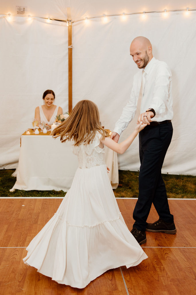 Groom spinning with daughter at wedding elopement