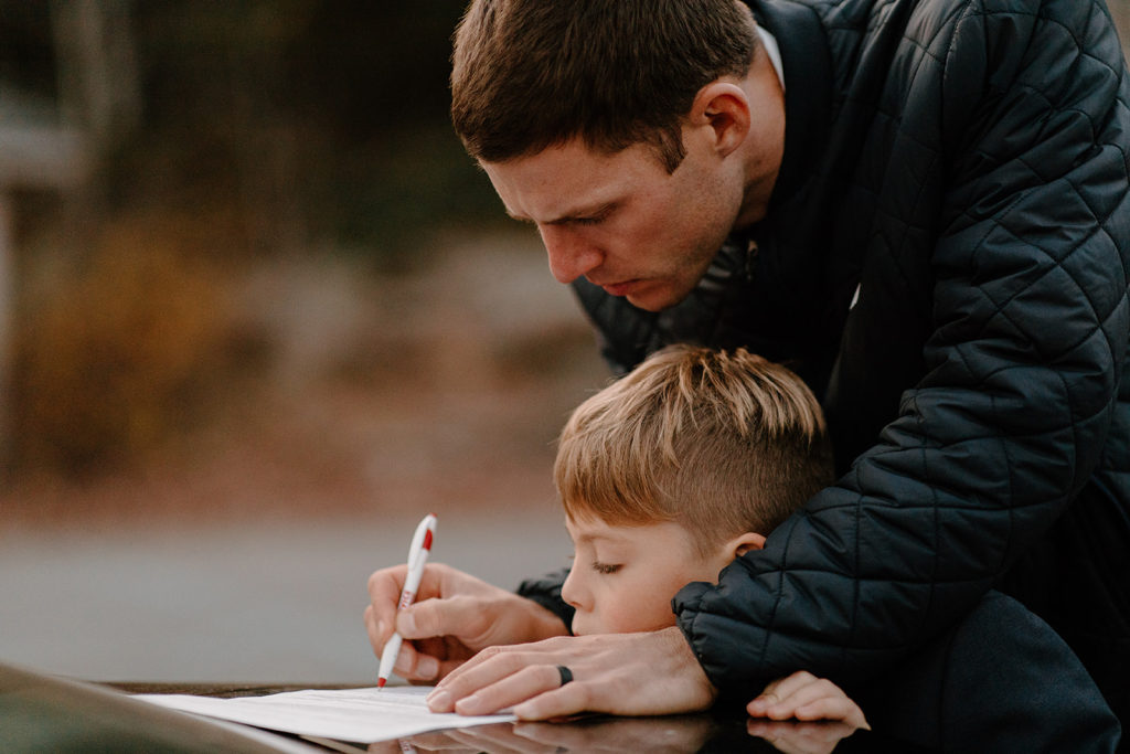 Father and son signing elopement license