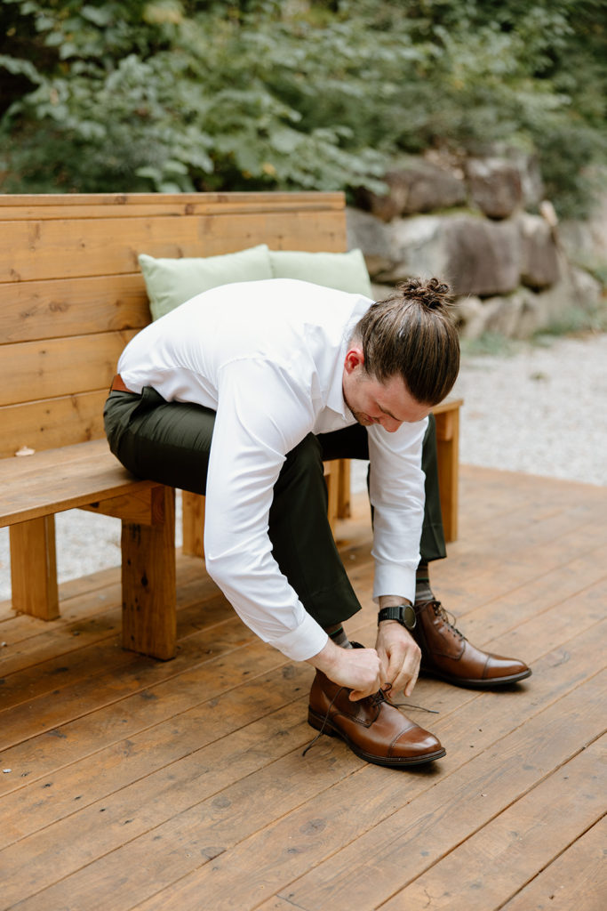 Groom getting ready at elopement