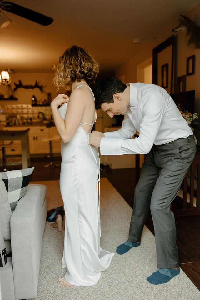 Bride getting ready with groom at elopement