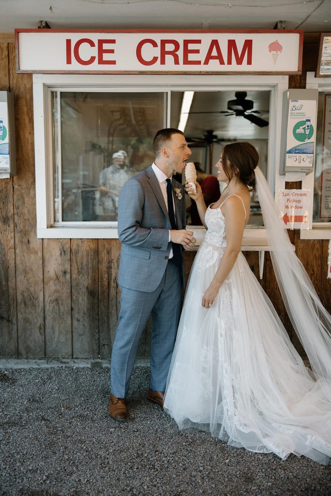 Bride and groom eating ice cream at adventure elopement in Vermont