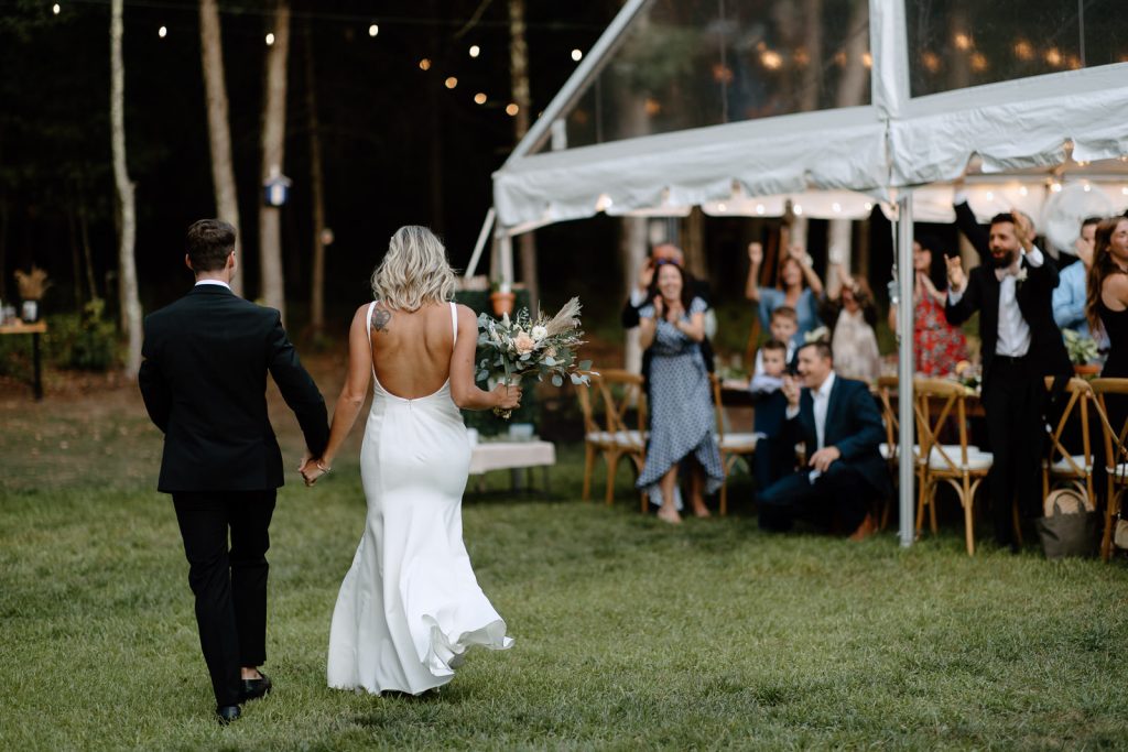 DIY backyard wedding in New Hampshire in the woods. Reception with clear tent.