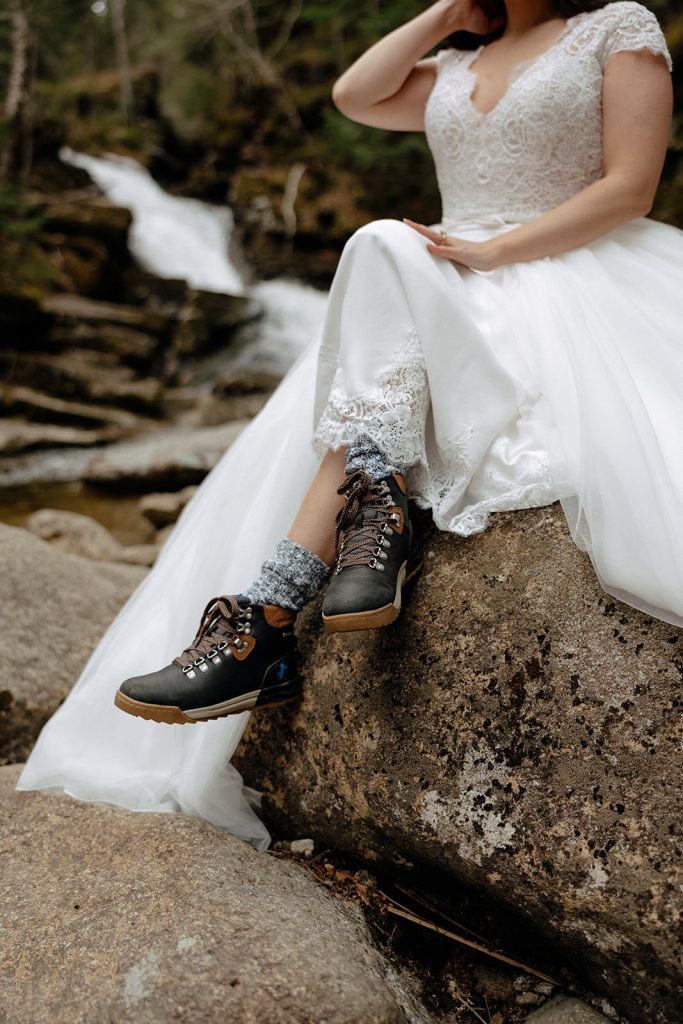 Elopement bride in boots at waterfall in New Hampshire