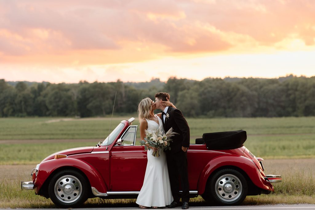 Elopement photo at sunset with old red car